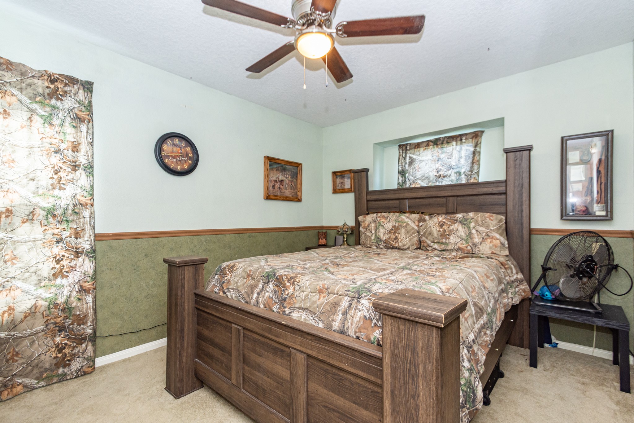 3625 County Road 36 Angleton, TX 77515 - Photo 31 of 50 a bedroom with a bed and a chandelier