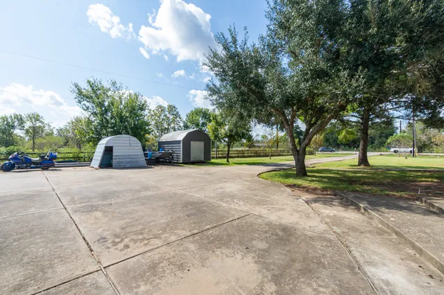 a view of outdoor space with garden and trees