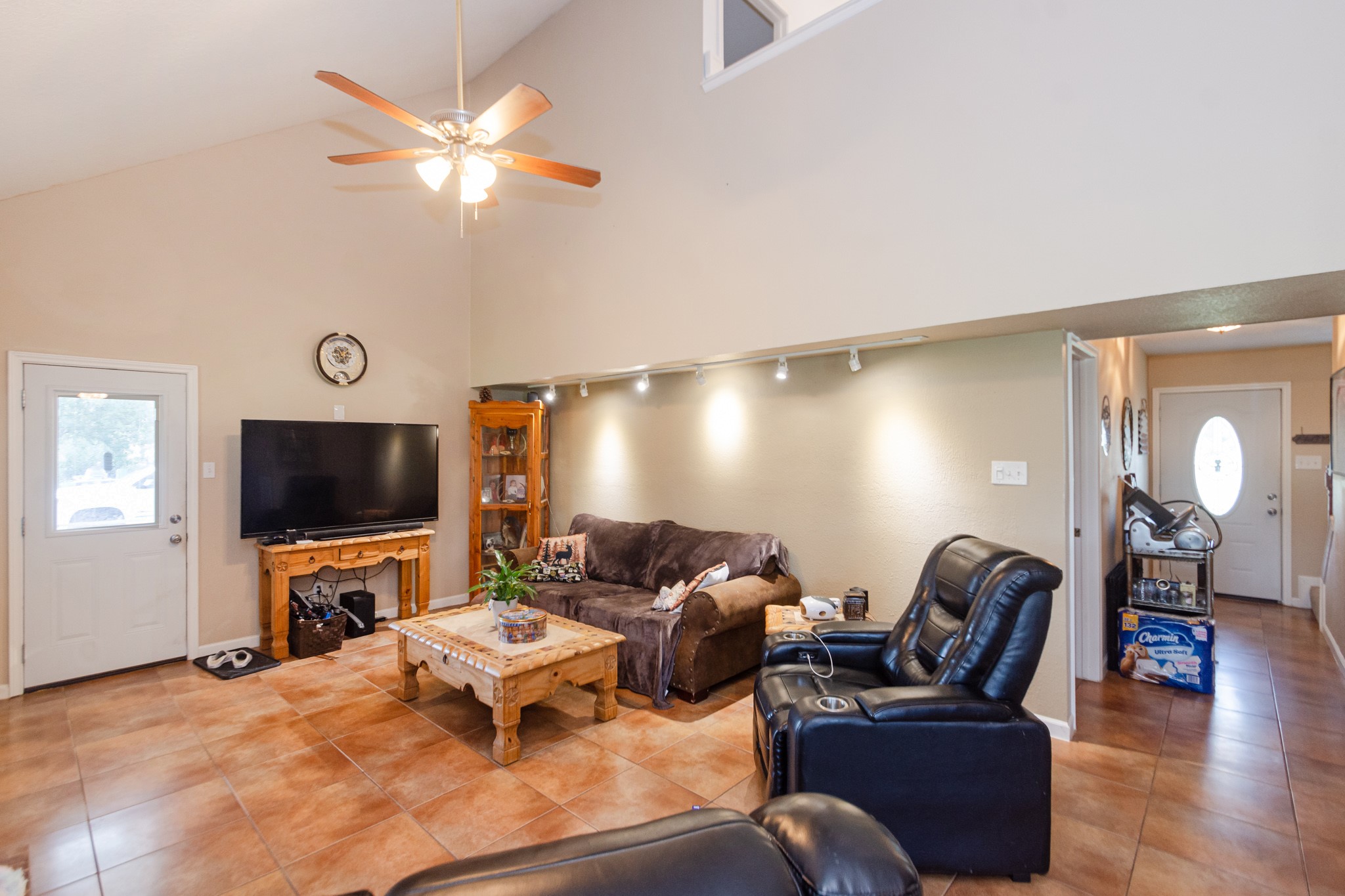 3625 County Road 36 Angleton, TX 77515 - Photo 7 of 50 a living room with furniture a chandelier and a flat screen tv
