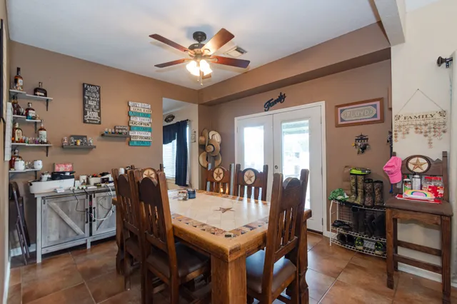 a view of a dining room with furniture and chandelier
