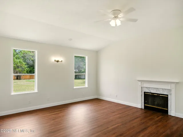 a view of staircase with railing and a window