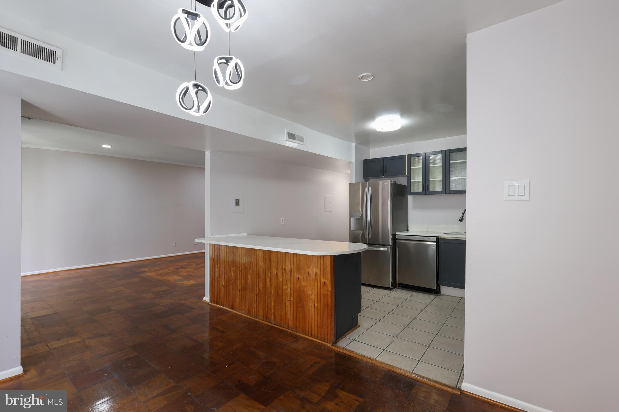 5050 7th Road South, Unit 301 Arlington, VA 22204 - Photo 8 of 20 a kitchen with stainless steel appliances a refrigerator and a stove