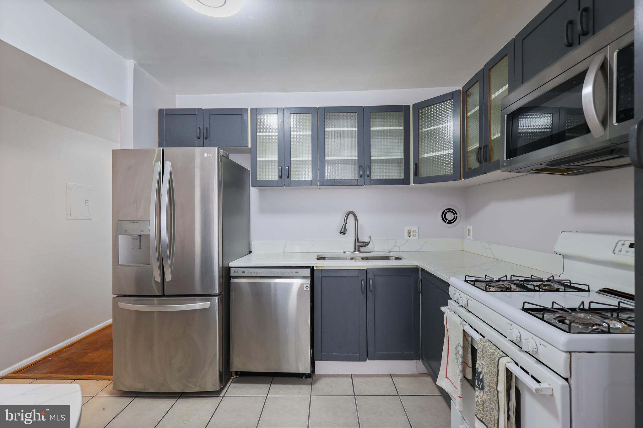 5050 7th Road South, Unit 301 Arlington, VA 22204 - Photo 9 of 20 a kitchen with stainless steel appliances granite countertop a sink stove and refrigerator