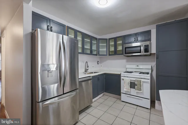 a kitchen with stainless steel appliances granite countertop a refrigerator stove a sink and dishwasher