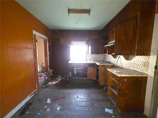 a kitchen with granite countertop a stove and a sink