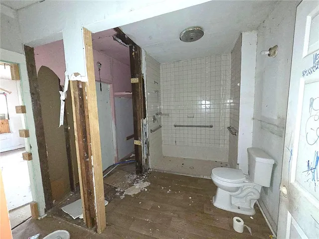 a view of a room with wooden floor