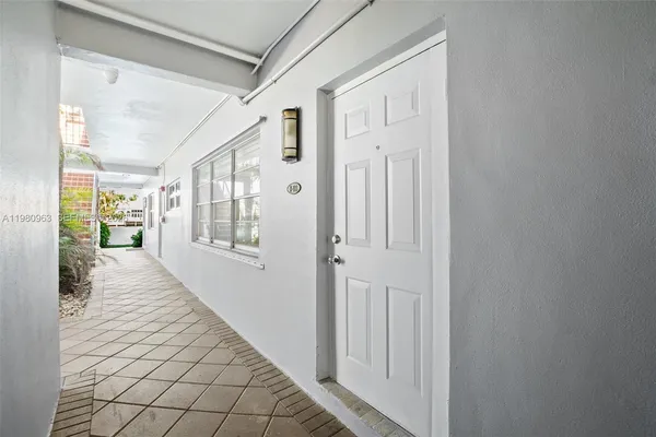 a hallway with wooden floor windows and stairs