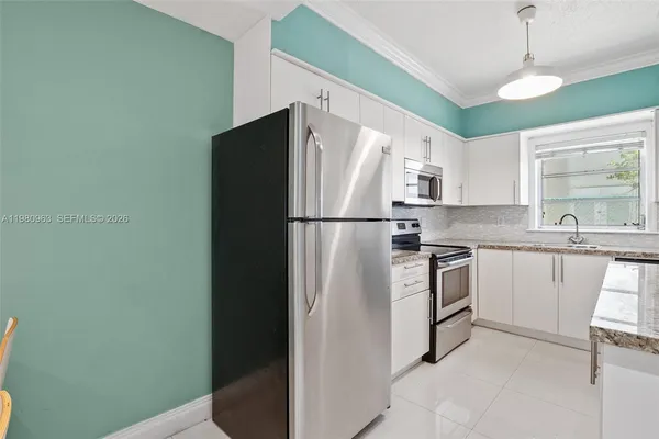 a kitchen with stainless steel appliances a refrigerator and a sink
