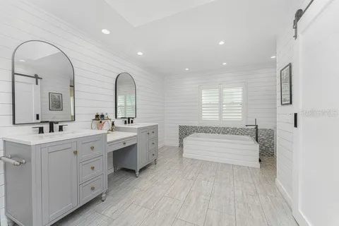a bathroom with a glass shower door and a sink