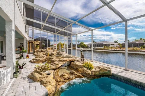 a view of a lake with a table and chairs