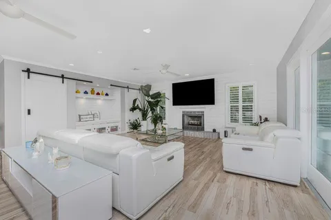 a dining room with furniture potted plants and wooden floor