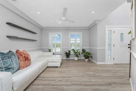 a kitchen with white cabinets and wooden floor