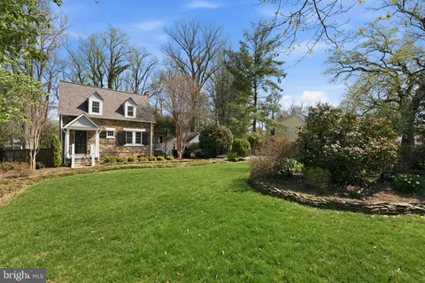a front view of house with yard and outdoor seating