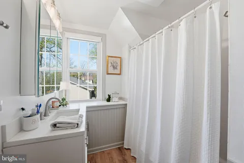 a room with a window a sink and washer dryer