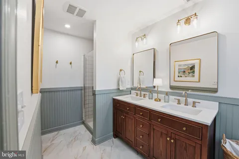 a bathroom with a double vanity sink and mirror