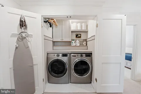 a view of a hallway with washer and dryer