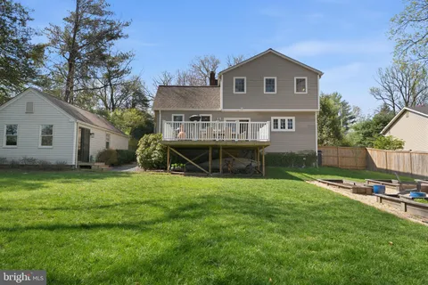 a front view of a house with a garden and deck