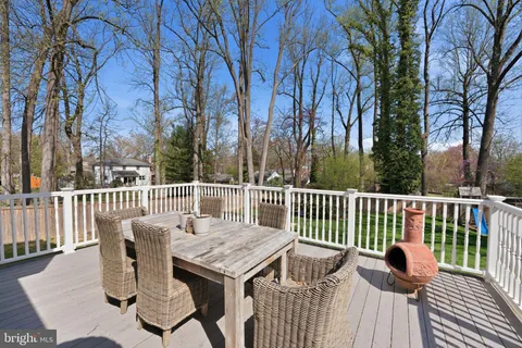a view of balcony with wooden floor and outdoor seating