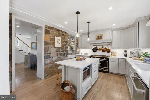 a kitchen with a stove a sink a refrigerator and cabinets