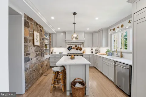 a kitchen with sink cabinets and wooden floor