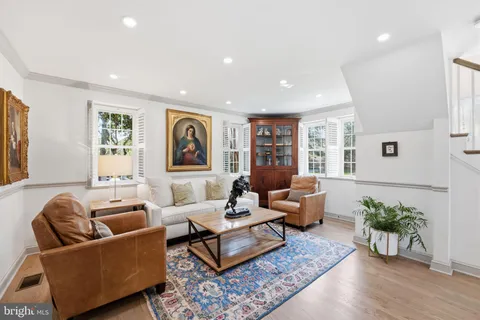 a living room with furniture potted plant and window