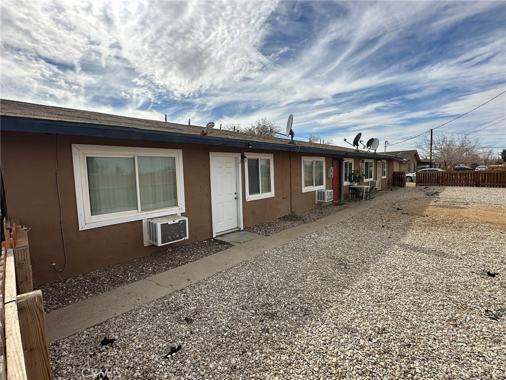 11895 White Avenue Adelanto, CA 92301 - Photo 4 of 21 a view of a house with a yard and wooden fence