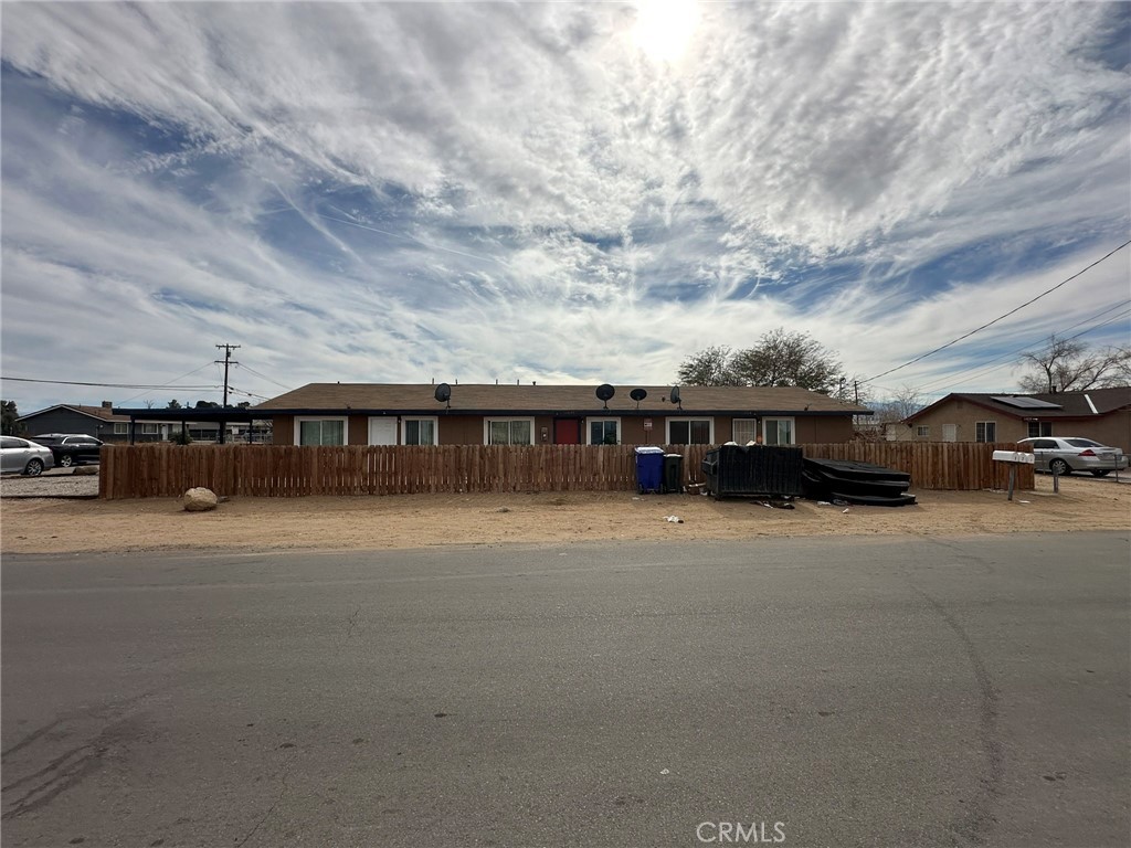 11895 White Avenue Adelanto, CA 92301 - Photo 6 of 21 a front view of a house with cars parked