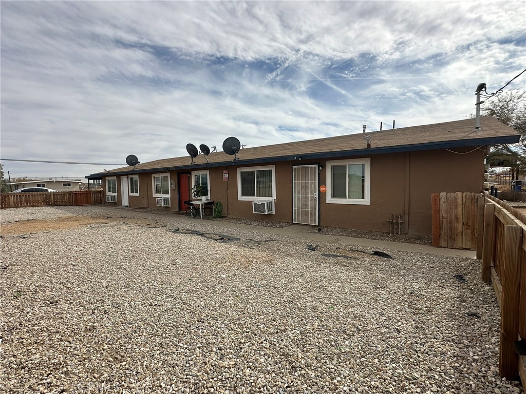 11895 White Avenue Adelanto, CA 92301 - Photo 8 of 21 a black and white building with trees in front of it