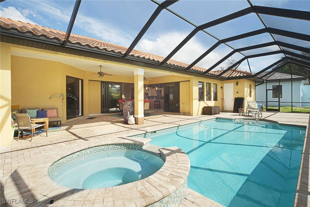 1502 Southwest 38th Street Cape Coral, FL 33914 - Photo 1 of 17 a swimming pool with outdoor seating and living room