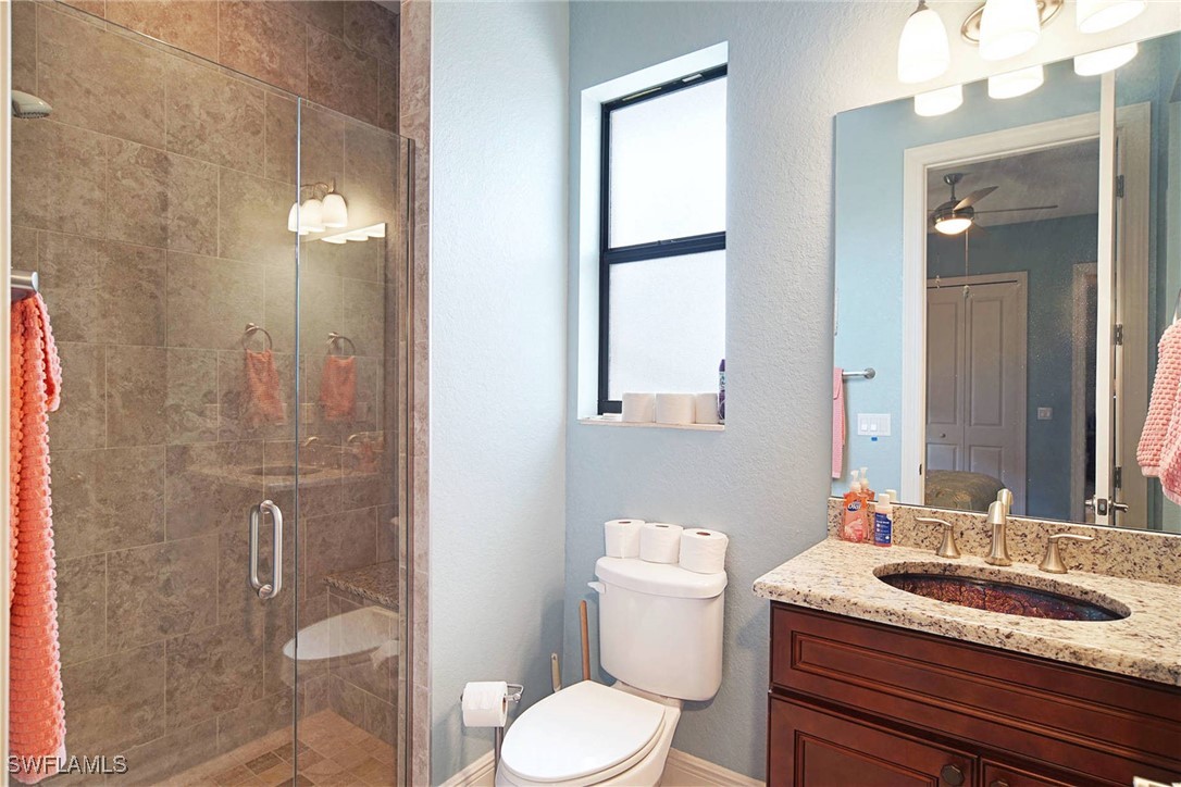 1502 Southwest 38th Street Cape Coral, FL 33914 - Photo 15 of 17 a bathroom with a granite countertop sink toilet a mirror and shower