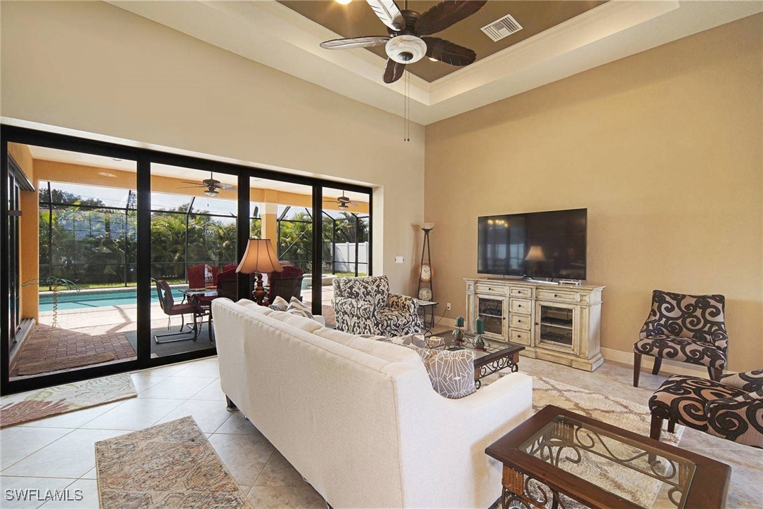 1502 Southwest 38th Street Cape Coral, FL 33914 - Photo 5 of 17 a living room with furniture large windows and flat screen tv