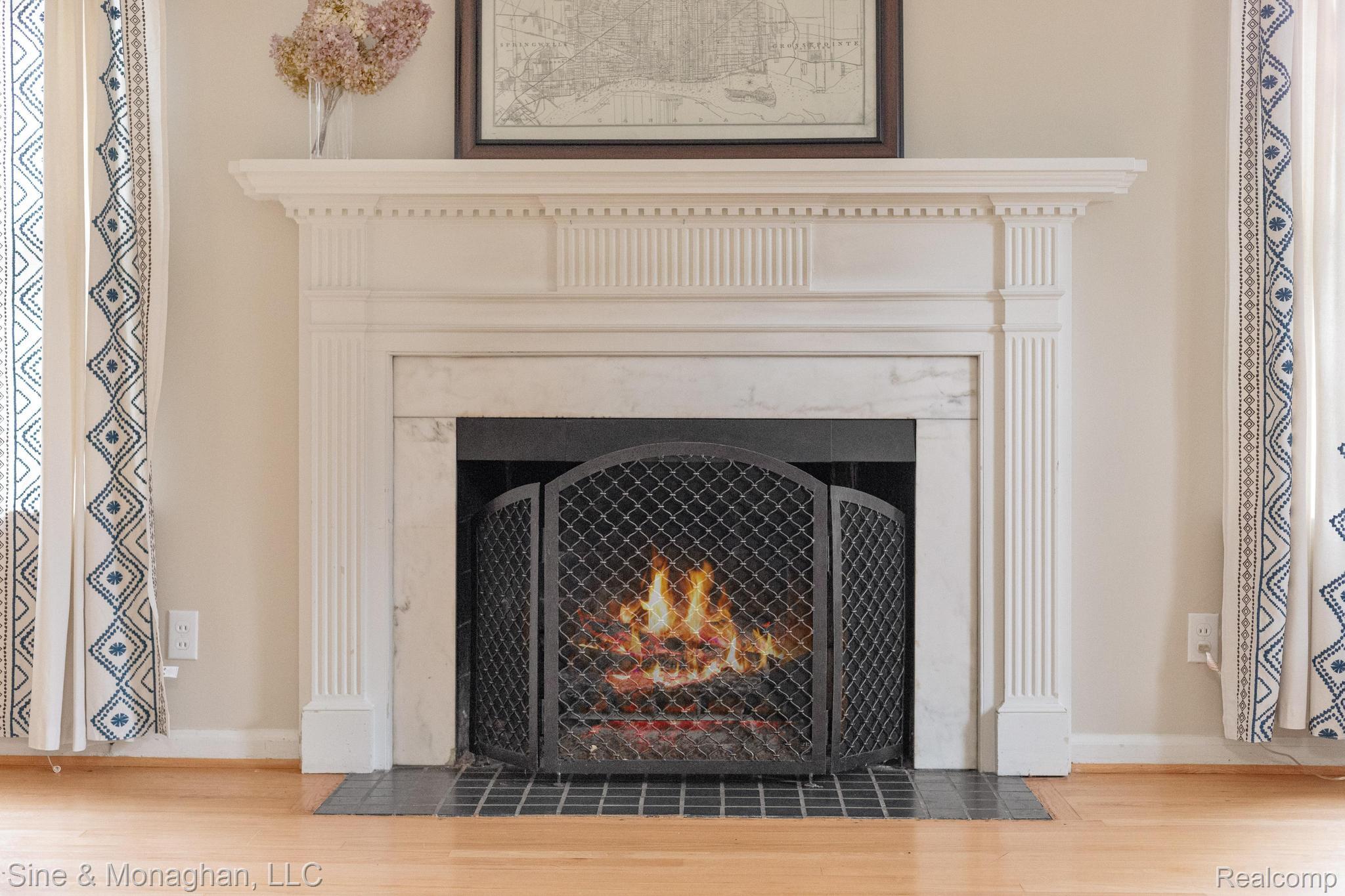 679 Neff Road Grosse Pointe, MI 48230 - Photo 7 of 78 Fireplace featuring a white mantel, marble surround, and dark tile hearth