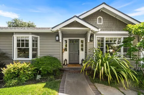 a front view of a house with a garden