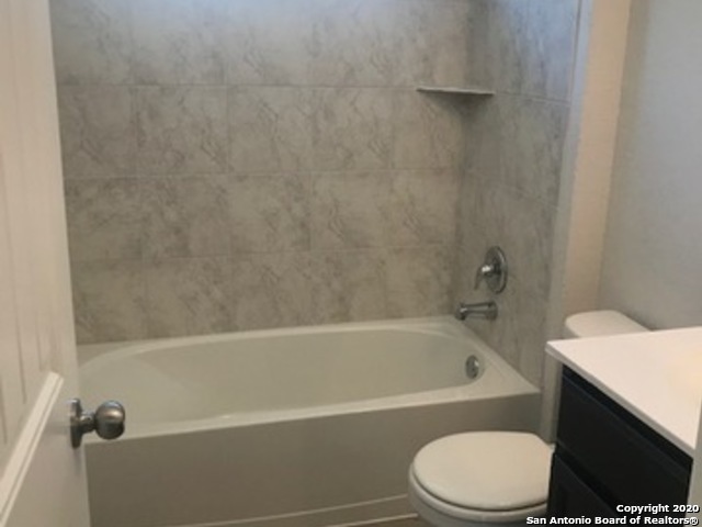9519 River Rye San Antonio, TX 78254 - Photo 14 of 28 a white bath tub sitting next to a white toilet and sink