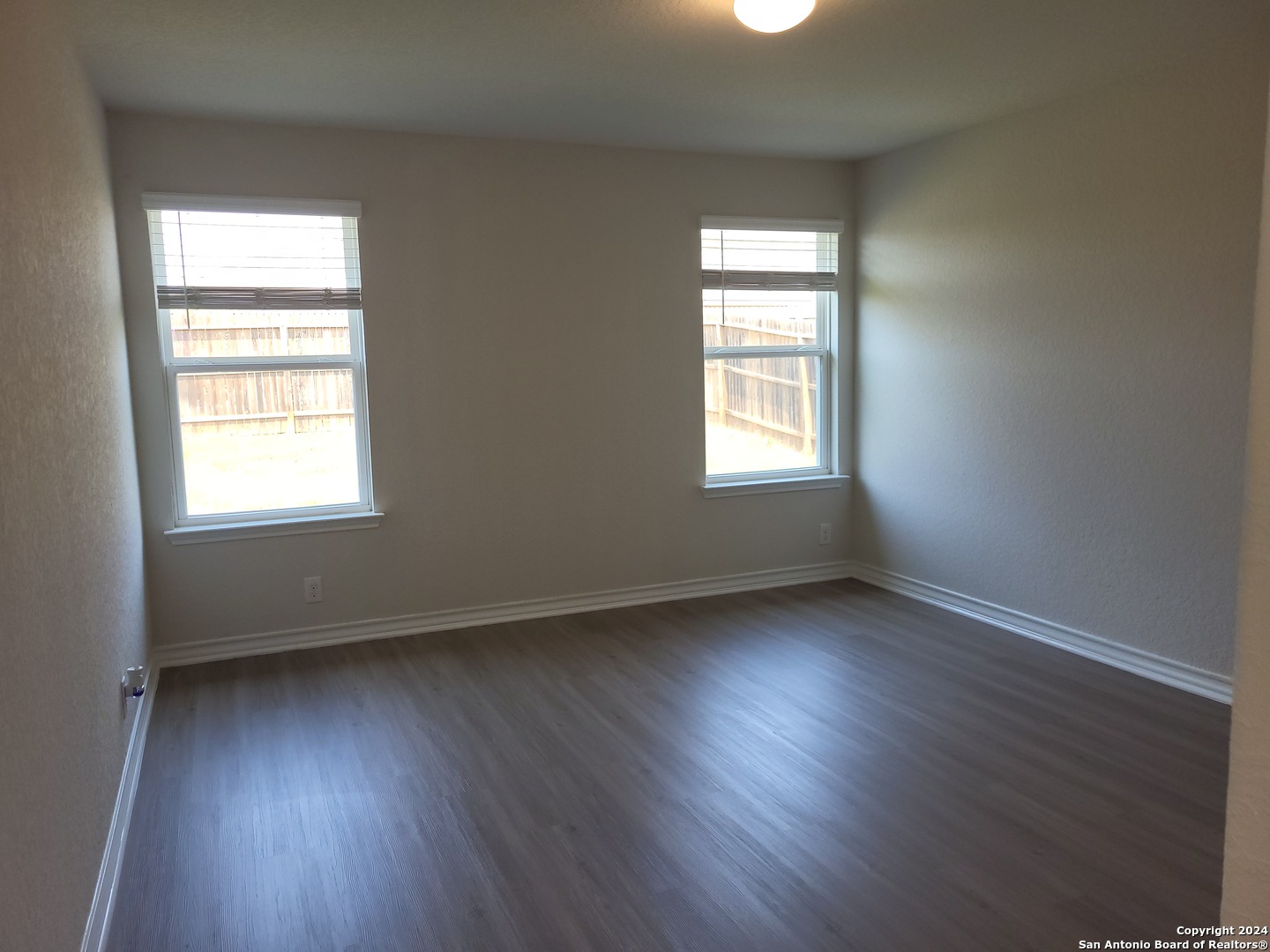 9519 River Rye San Antonio, TX 78254 - Photo 19 of 28 an empty room with wooden floor and windows