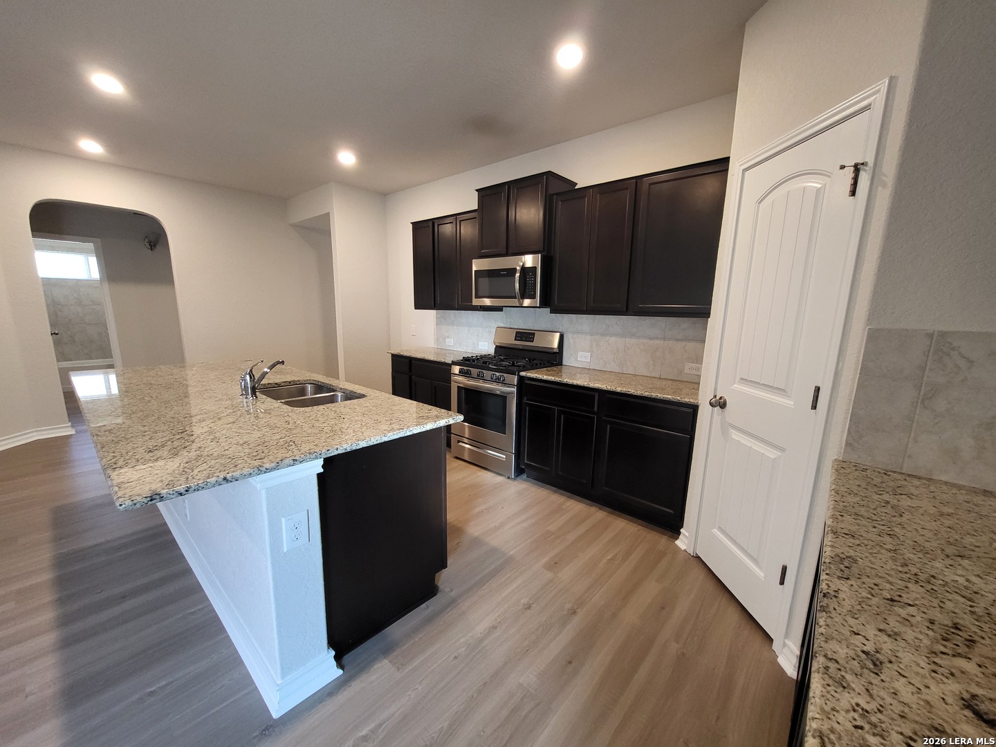 9519 River Rye San Antonio, TX 78254 - Photo 6 of 28 a large kitchen with stainless steel appliances sink a microwave and cabinets