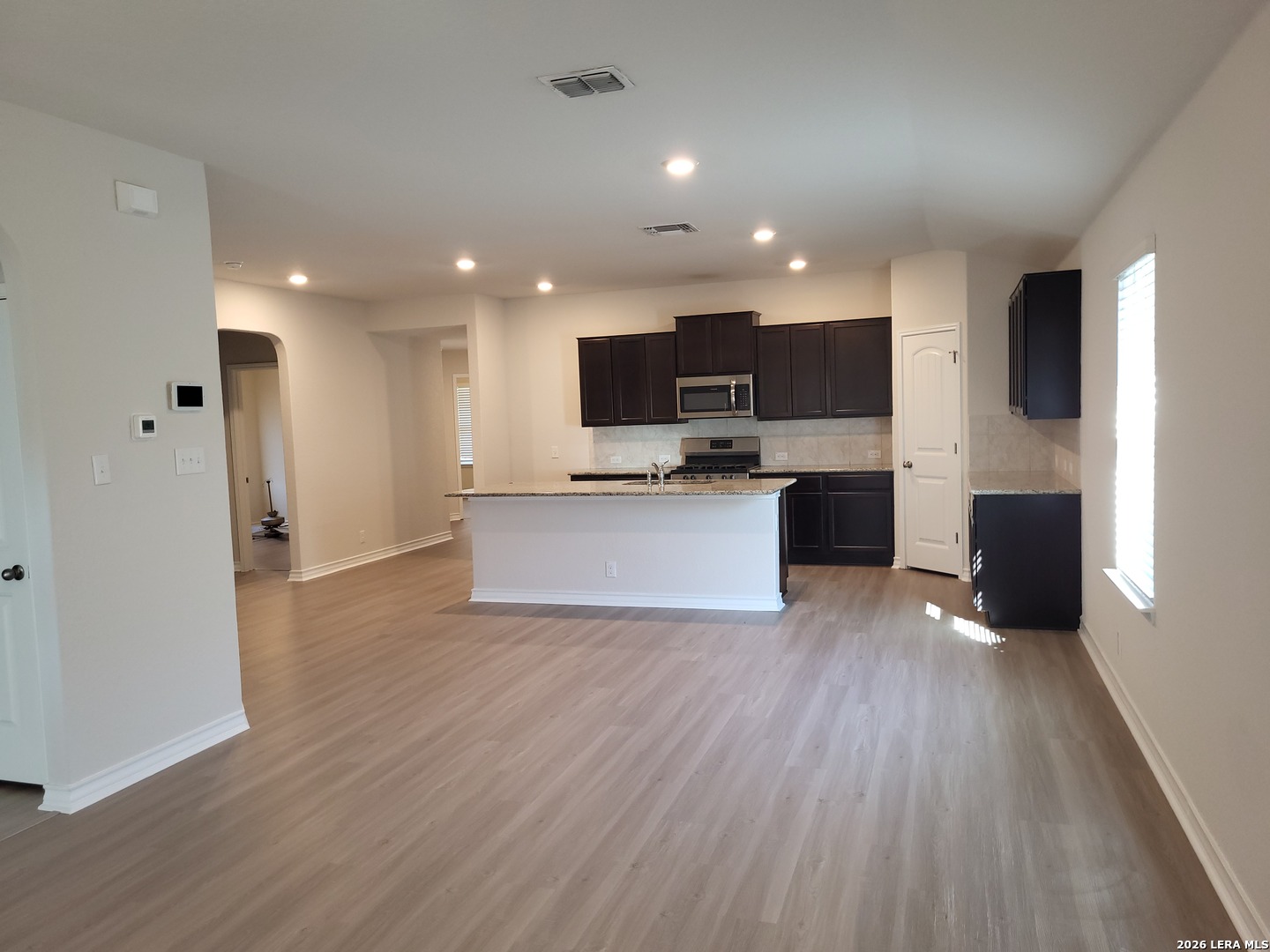 9519 River Rye San Antonio, TX 78254 - Photo 7 of 28 a view of kitchen with microwave oven a refrigerator and cabinets