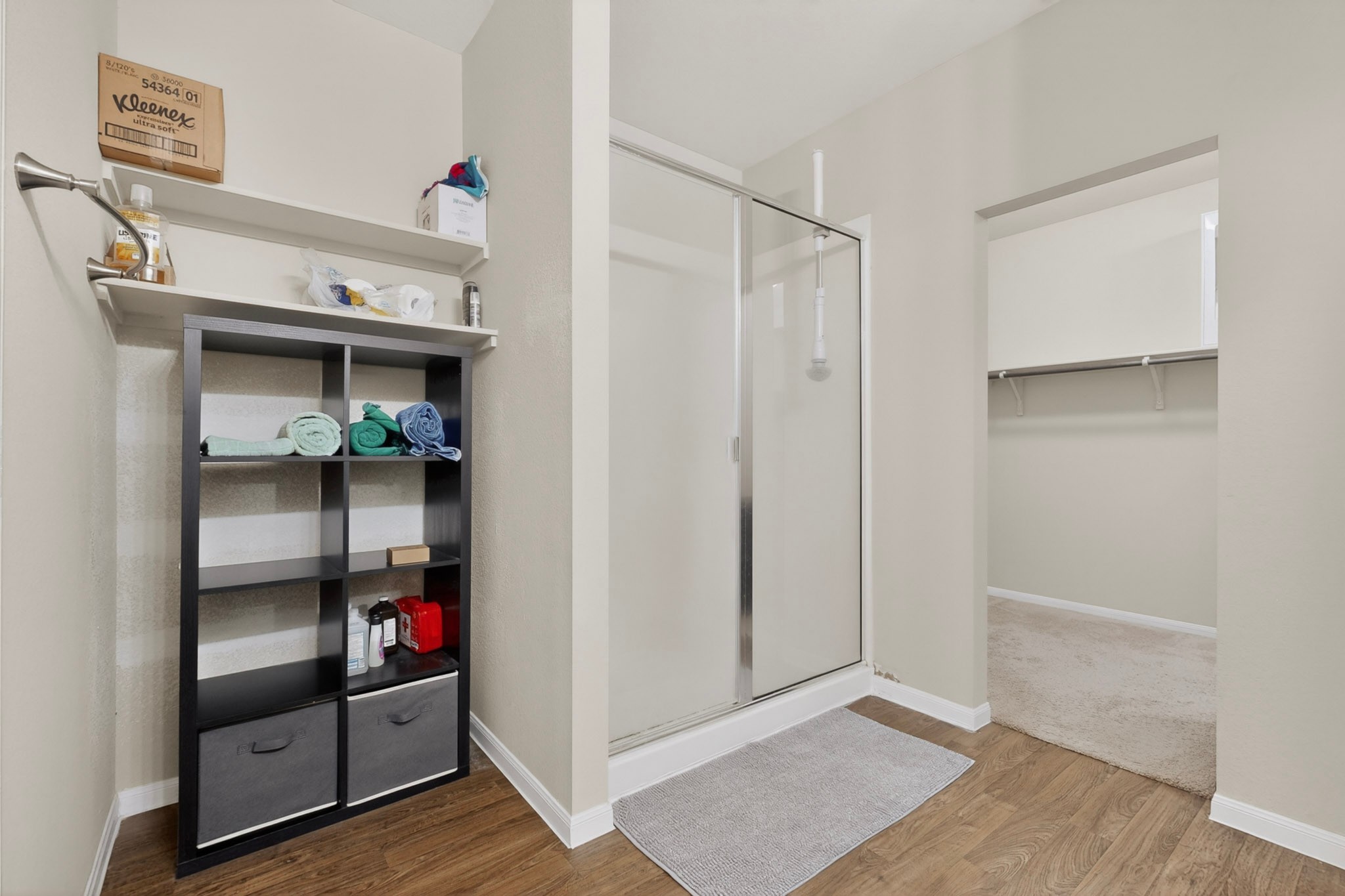 14513 Esker Road Manor, TX 78653 - Photo 18 of 38 A well-appointed bath boasts a sleek walk-in shower and ample shelving for organized storage.