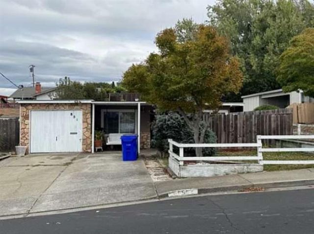 a view of backyard with deck and a potted plant
