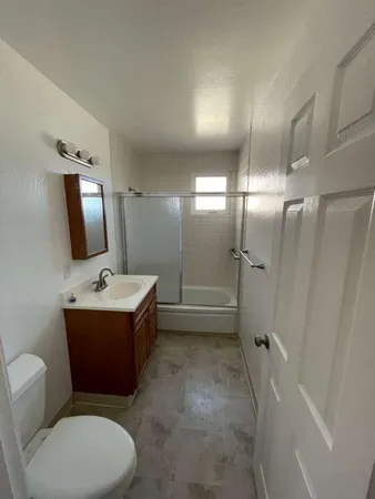 a bathroom with a sink mirror vanity and toilet