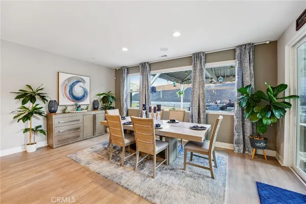 a dinning room and kitchen with a table chairs