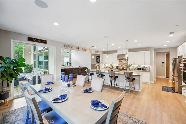 a kitchen with stainless steel appliances granite countertop a refrigerator stove and sink
