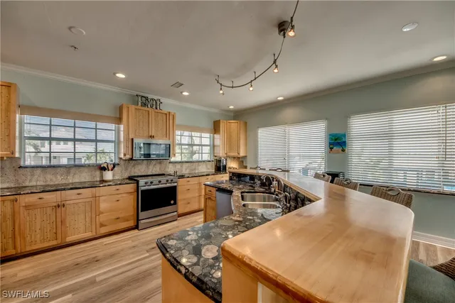 a large kitchen with lots of counter space a sink and appliances