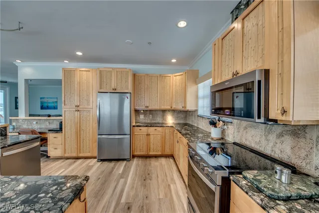 a kitchen with a refrigerator sink and cabinets