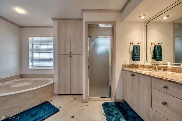 a bathroom with a tub sink and mirror