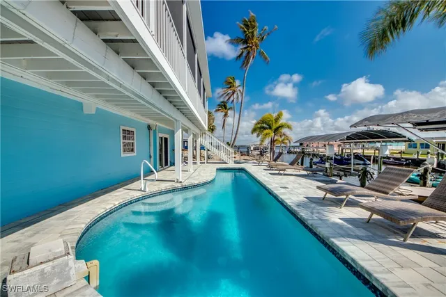 a view of a backyard with swimming pool