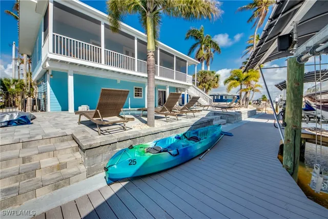 a view of a chairs and table on the wooden deck