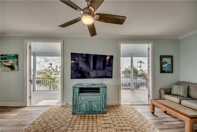 a living room with furniture a window and a flat screen tv