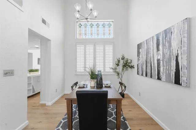 a view of a dining room with furniture and windows
