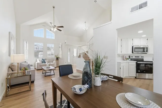 a living room with furniture and kitchen view